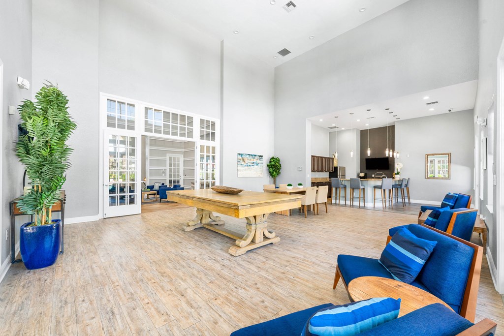 A living room with a blue couch and a wooden table.