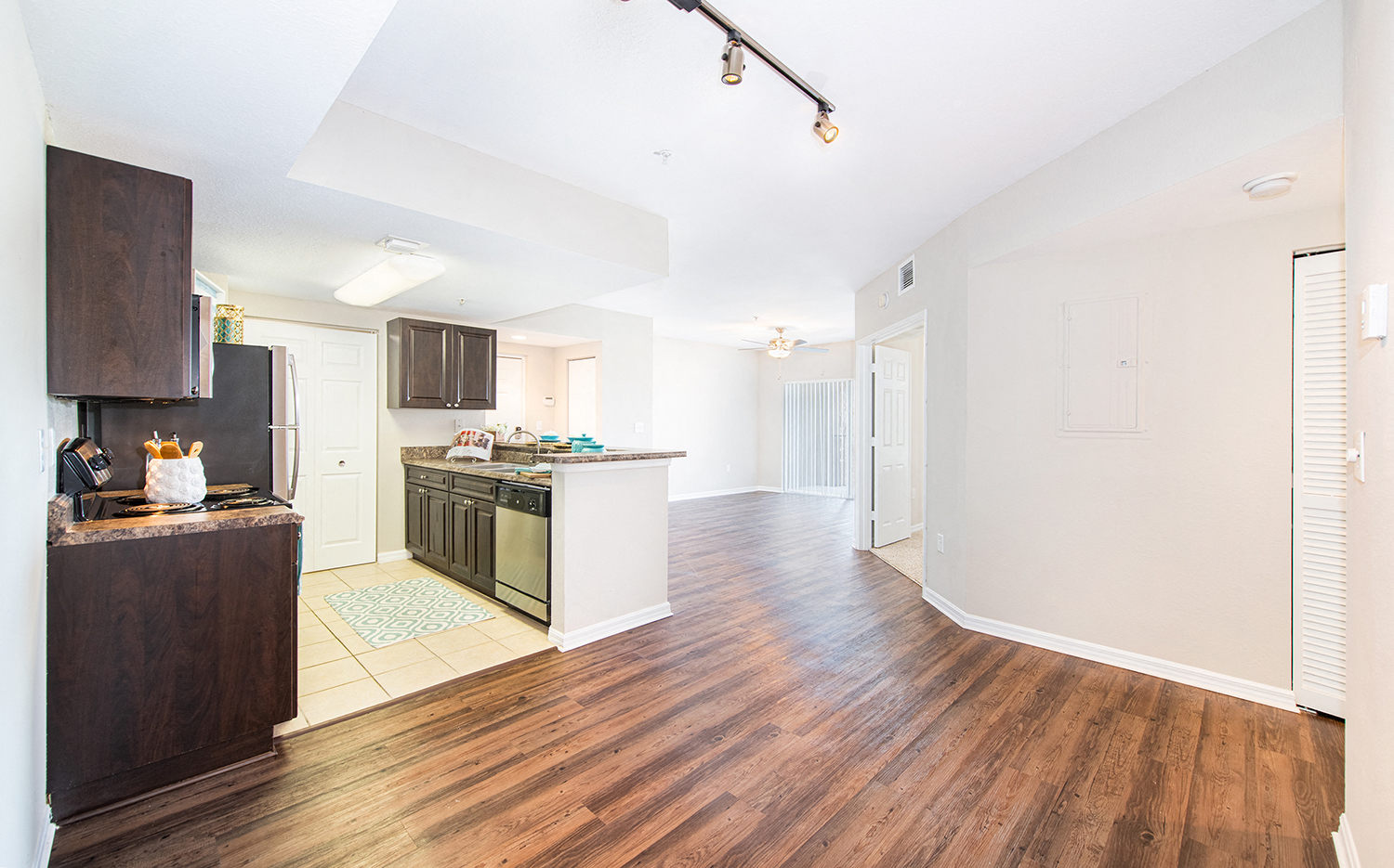 a renovated kitchen and living room with a hard wood floor
