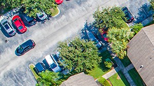 a birds eye view of a tennis court and a backyard with umbrellas