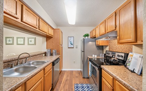 a kitchen with stainless steel appliances and wooden cabinets