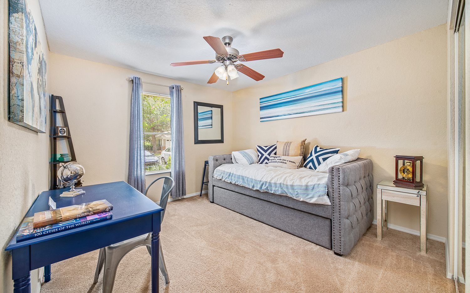 a bedroom with a bed and a ceiling fan