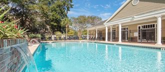a swimming pool with a house in the background
