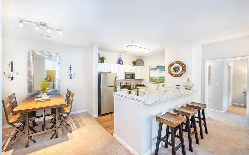 a living room with a kitchen and a dining table