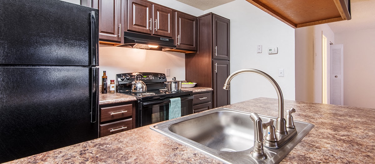 a kitchen with black appliances and granite counter tops