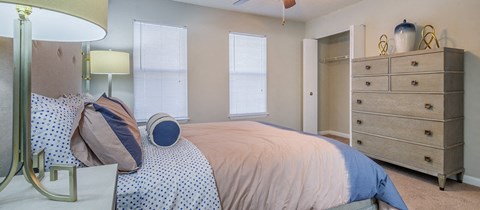 a bedroom with a bed and a dresser