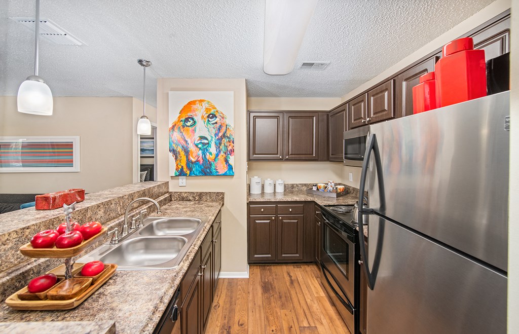 a kitchen with stainless steel appliances and granite counter tops