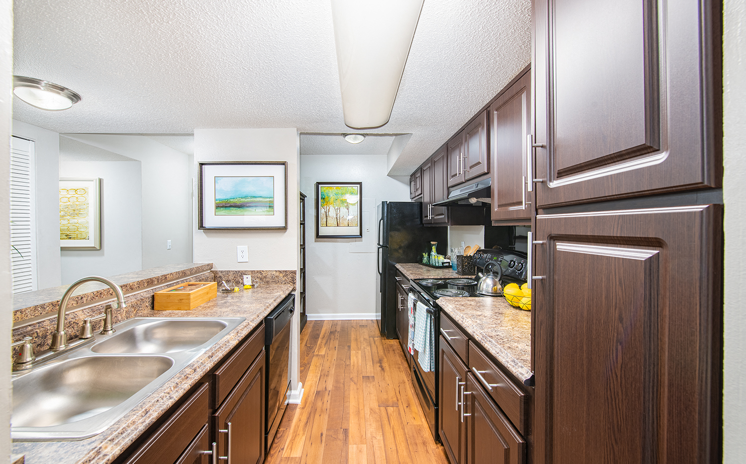 a large kitchen with wooden cabinets and granite counter tops