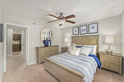 a bedroom with a bed and a ceiling fan