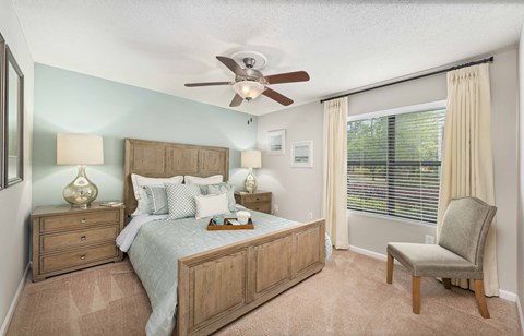 a bedroom with a bed and a ceiling fan