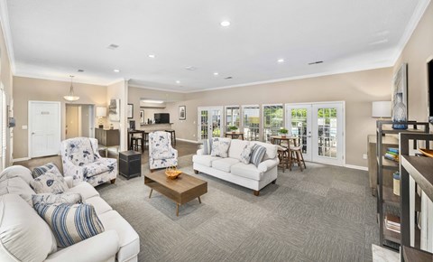 a living room with couches and chairs and a kitchen with a table