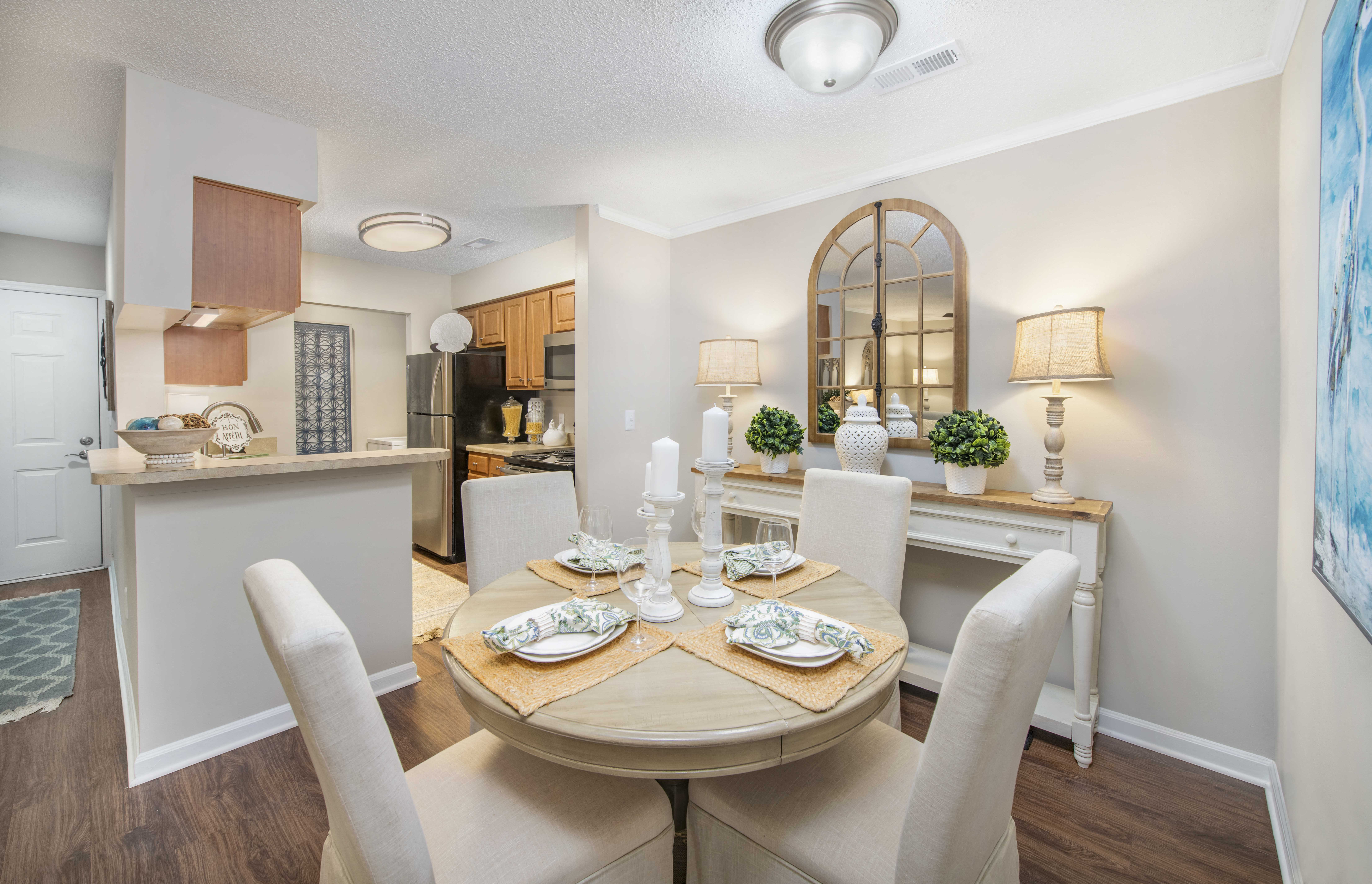 a dining room and kitchen with a table and chairs