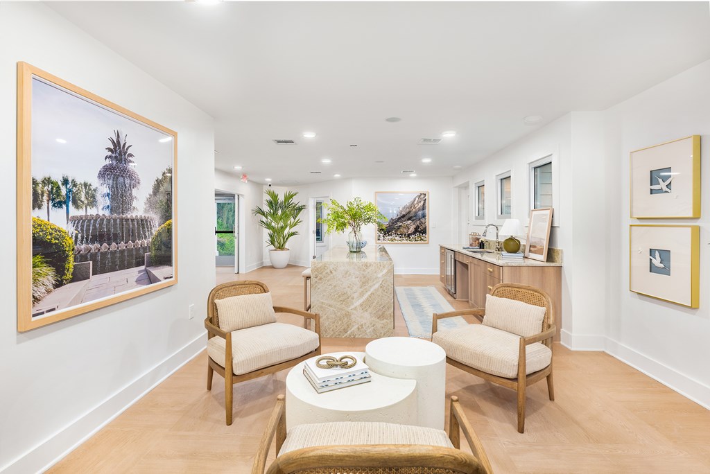 A living room with a painting of a street scene on the wall.