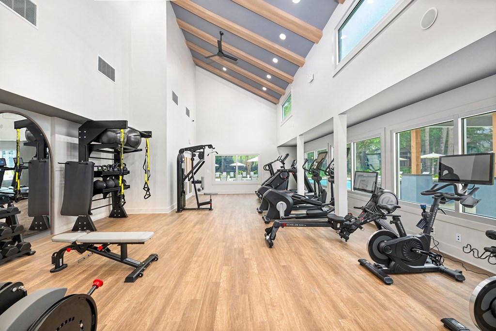 A gym with a variety of exercise equipment.