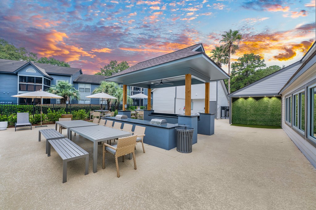 A patio with a table and chairs is set up outside a house.