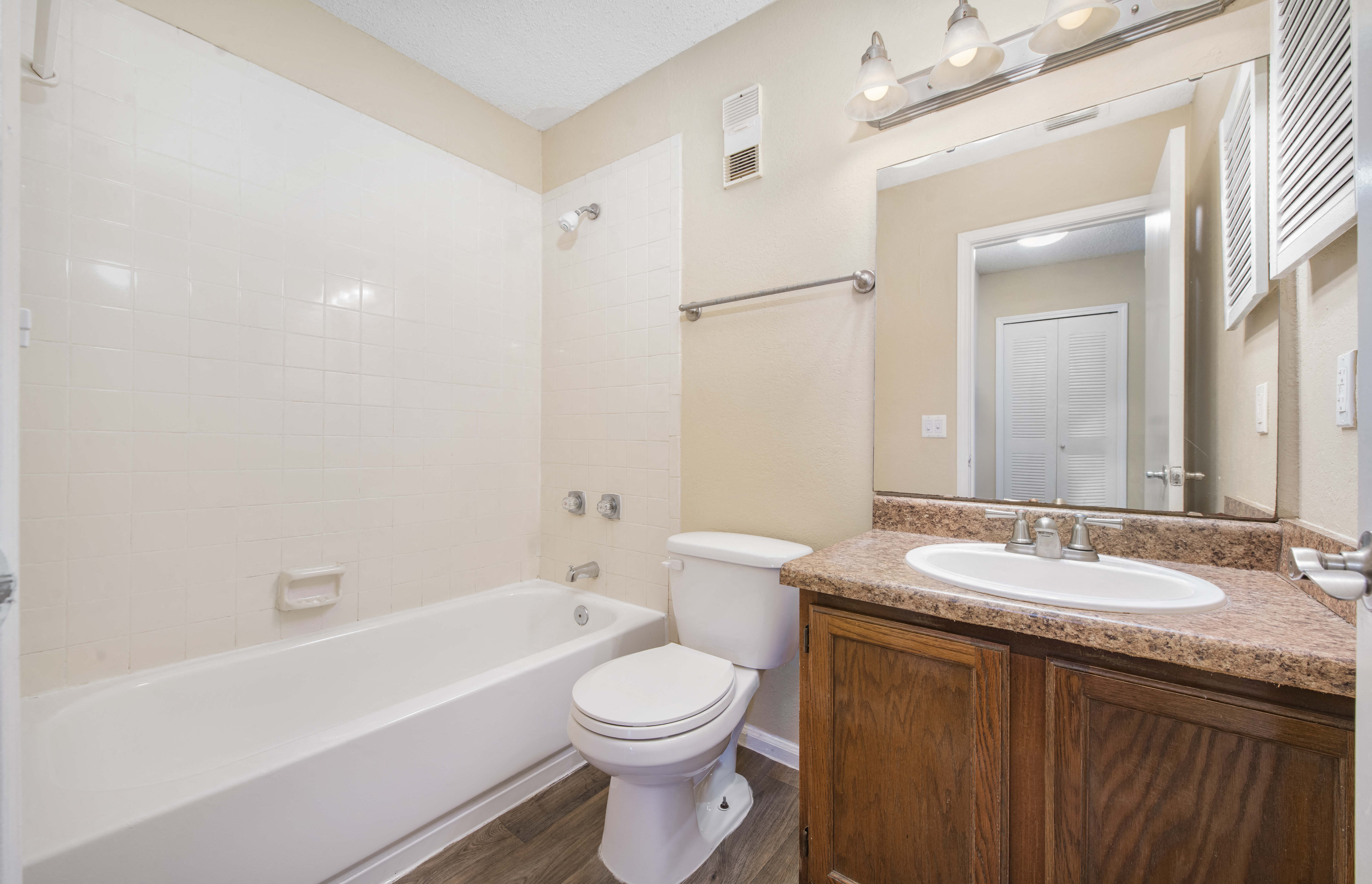 the preserve at ballantyne commons apartment bathroom with tub sink and mirror