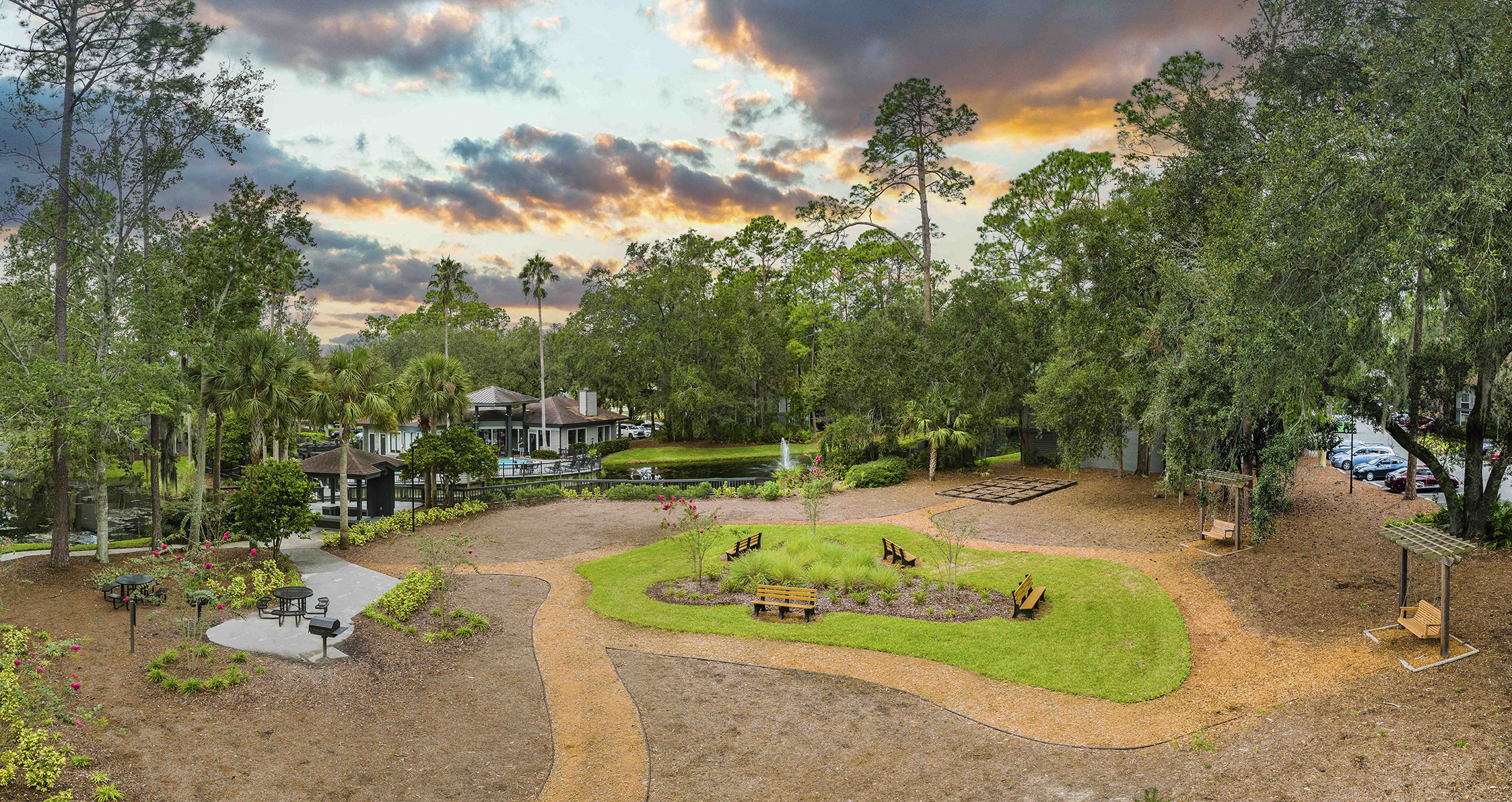 an aerial view of a park with trees and grass