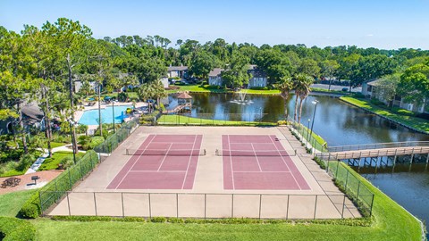 an aerial view of a tennis court overlooking the water