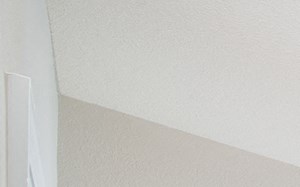 a bedroom with a large bed and a ceiling fan