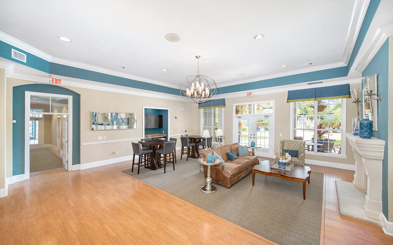 a living room with blue and white walls and a dining room