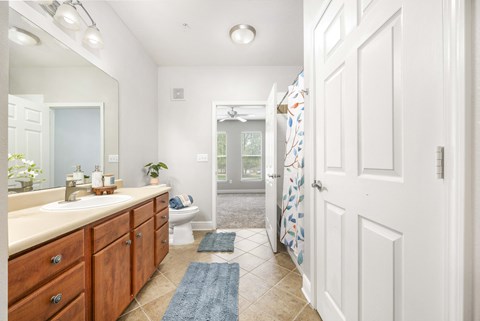 a bathroom with a shower and a sink and a toilet
