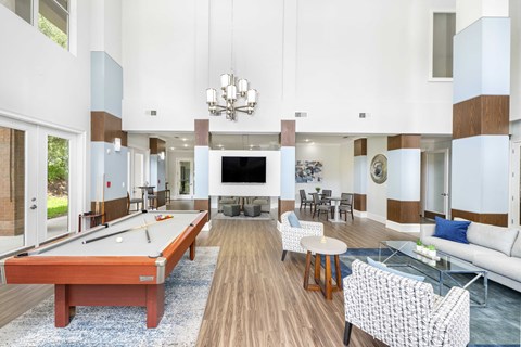 a clubhouse with a pool table and a tv