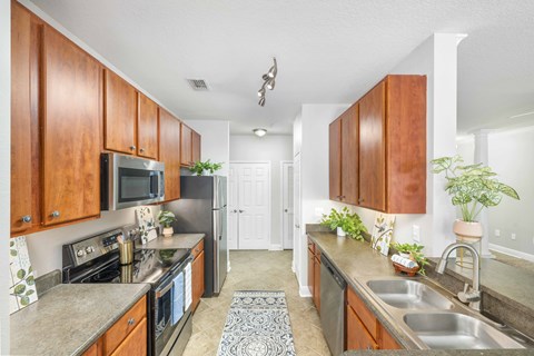 a kitchen with stainless steel appliances and wooden cabinets