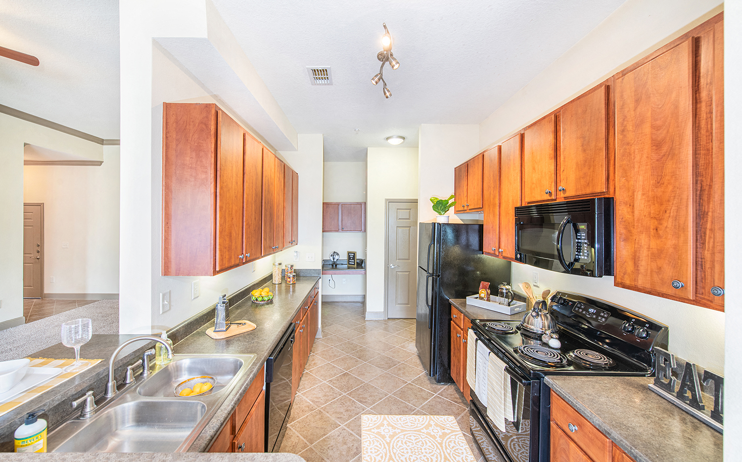 a kitchen with stainless steel appliances and wood cabinets