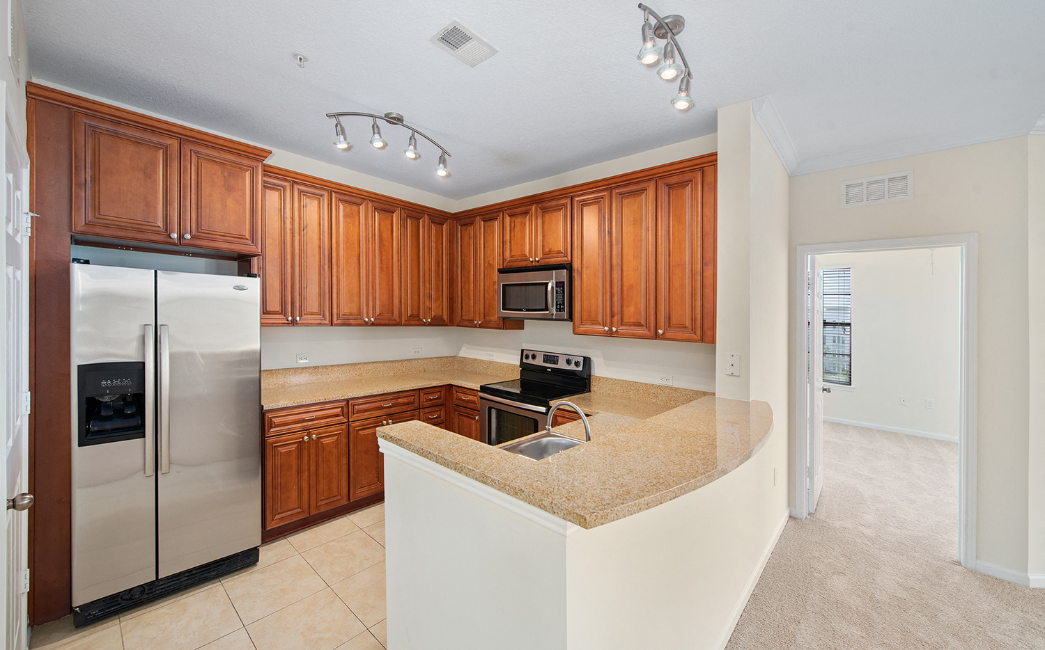 a kitchen with wooden cabinets and a counter top