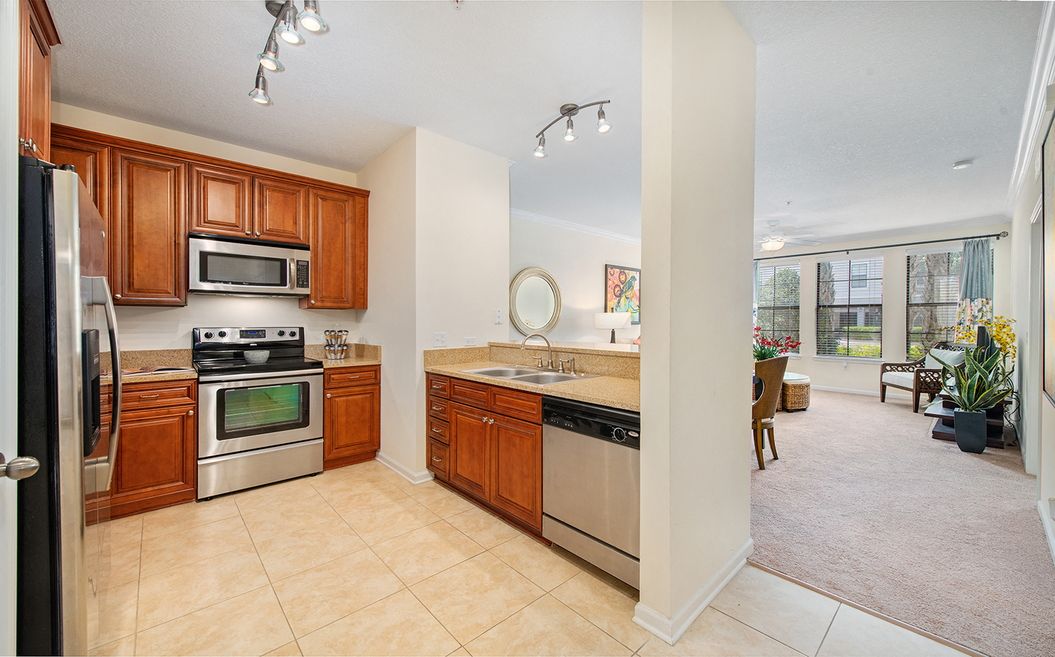 a kitchen with stainless steel appliances and wooden cabinets