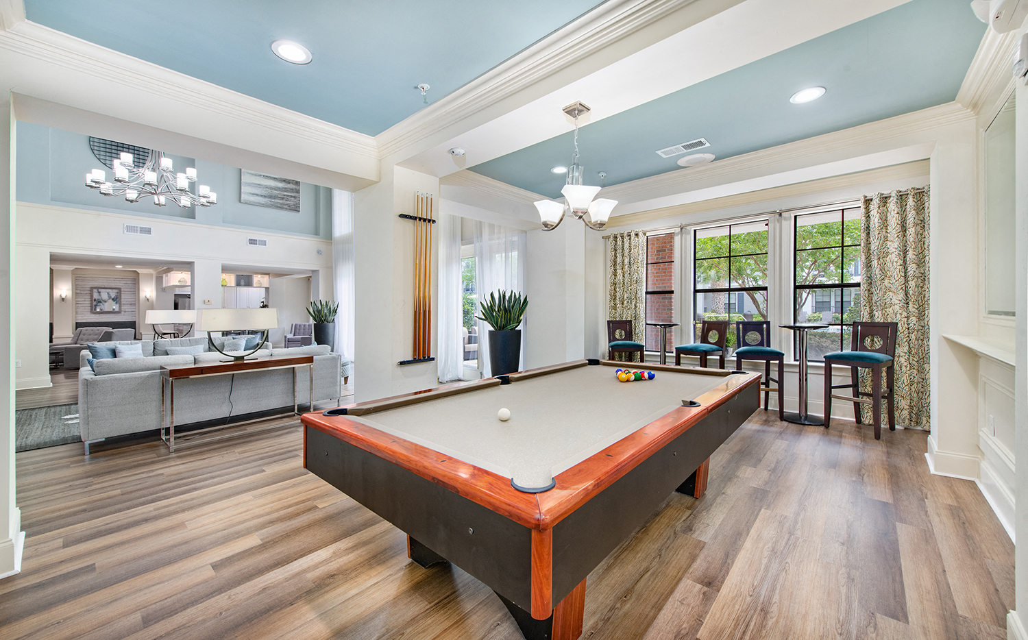 a game room with a pool table and a bar