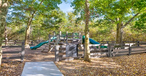 A playground with a slide and a signboard.