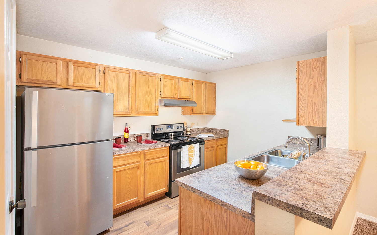 a kitchen with stainless steel appliances and wooden cabinets