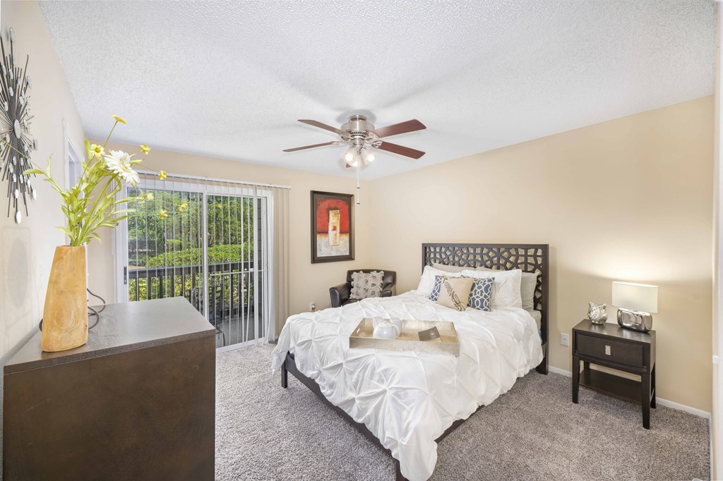 a bedroom with a bed and a ceiling fan