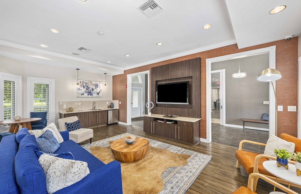 a living room with a blue couch and a tv