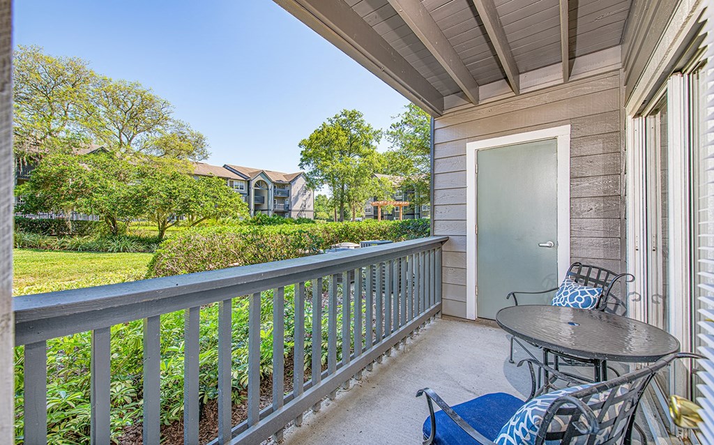 a patio with a table and chairs on a balcony