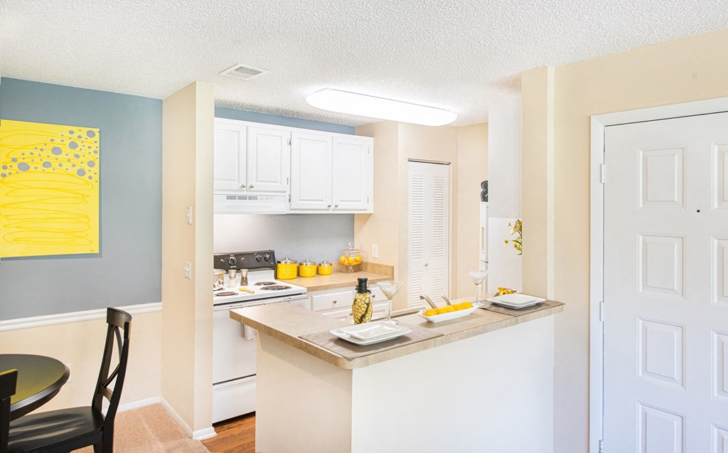 a kitchen with white cabinets and a counter top