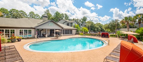 a swimming pool with a house in the background