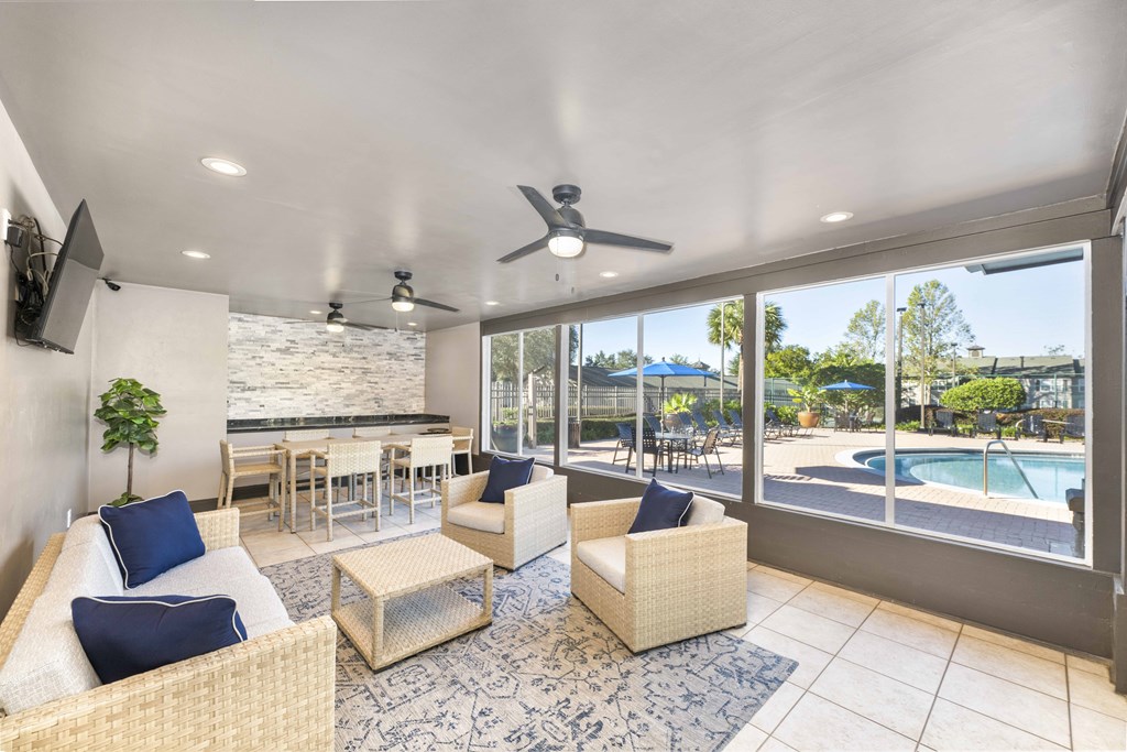 A spacious living room with a pool view.