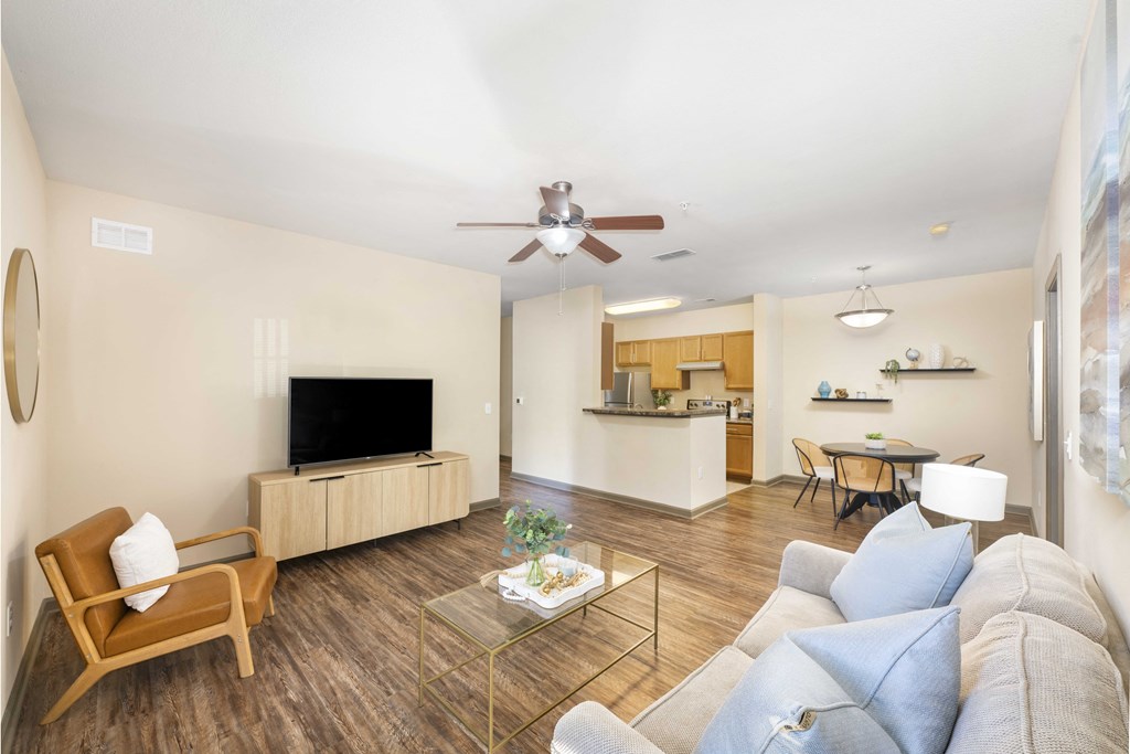 A living room with a wooden chair and a glass coffee table.