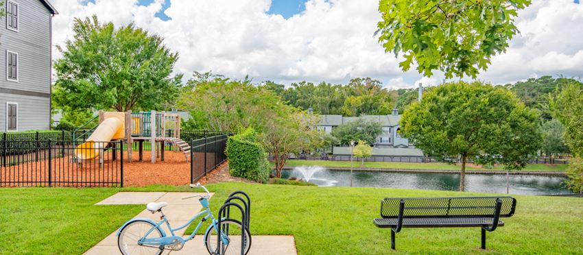 a park with a playground and a pond
