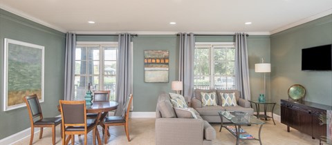 a living room with a couch and a table and chairs