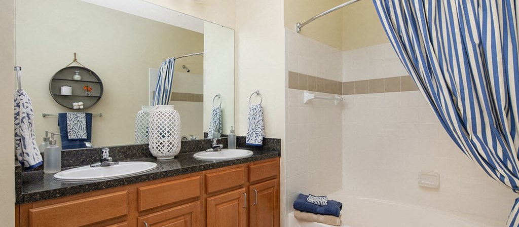 a bathroom with two sinks and a shower