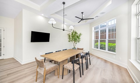 A dining room with a wooden table and chairs.