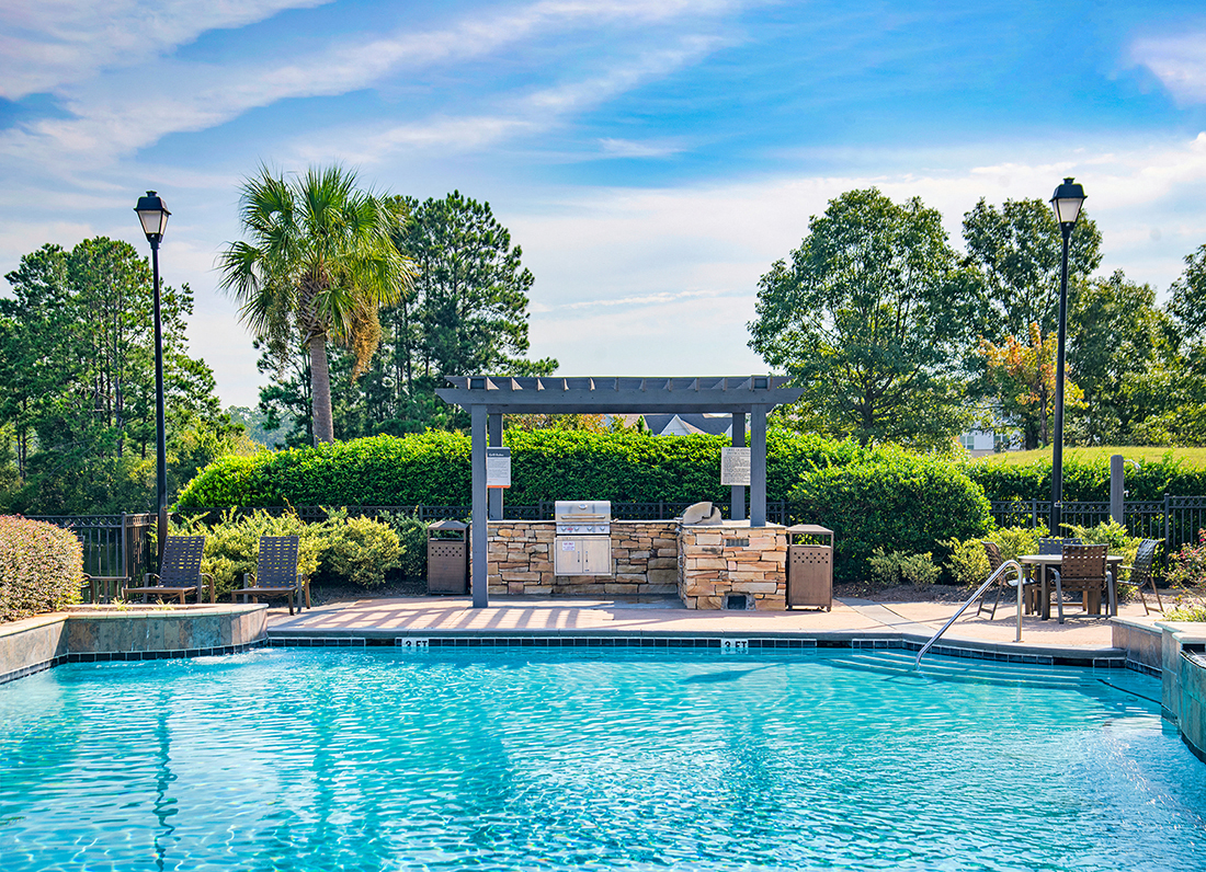 a swimming pool with a gazebo next to a resort pool