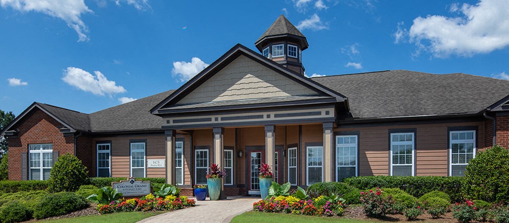 the front of a building with flowers in front of it