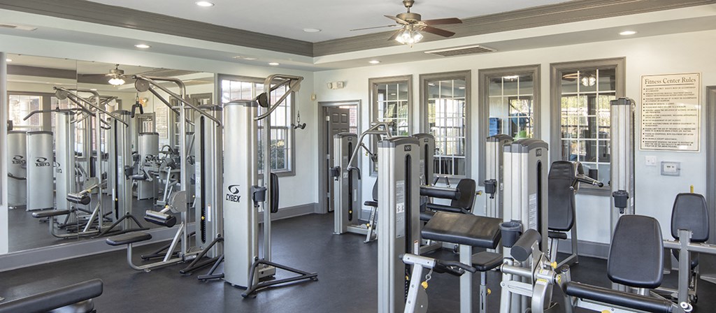 a gym with various exercise machines and weights