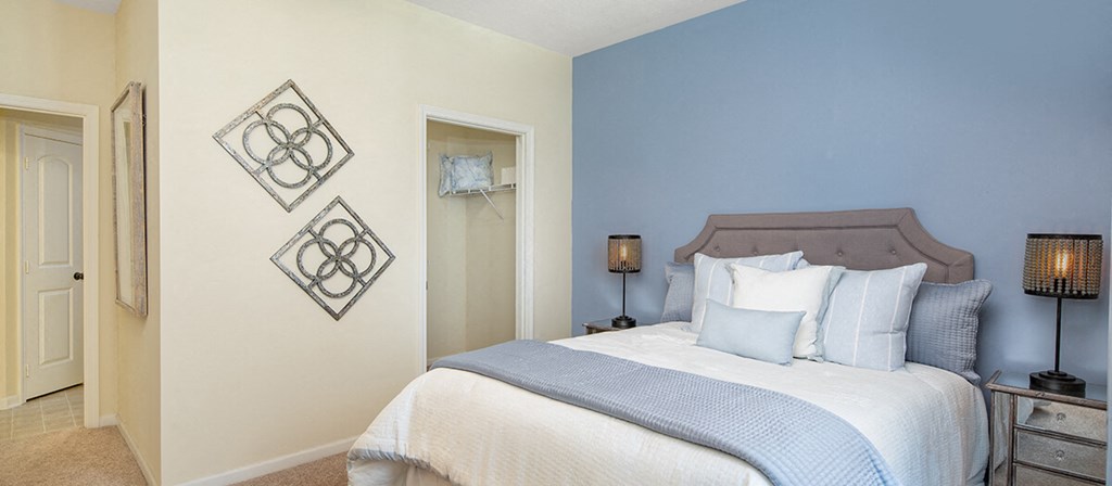 a bedroom with a bed and blue and white walls
