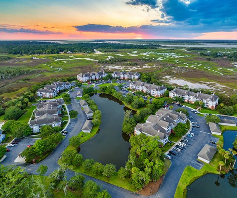 an aerial view of a neighborhood with a lake and houses