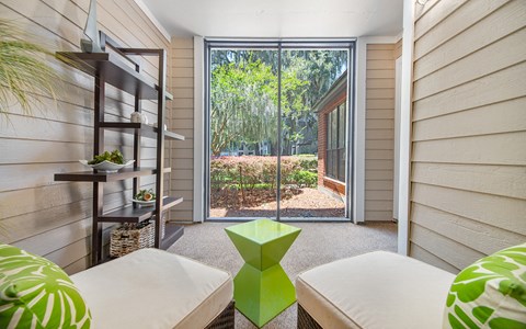 a living room with two couches and a glass door