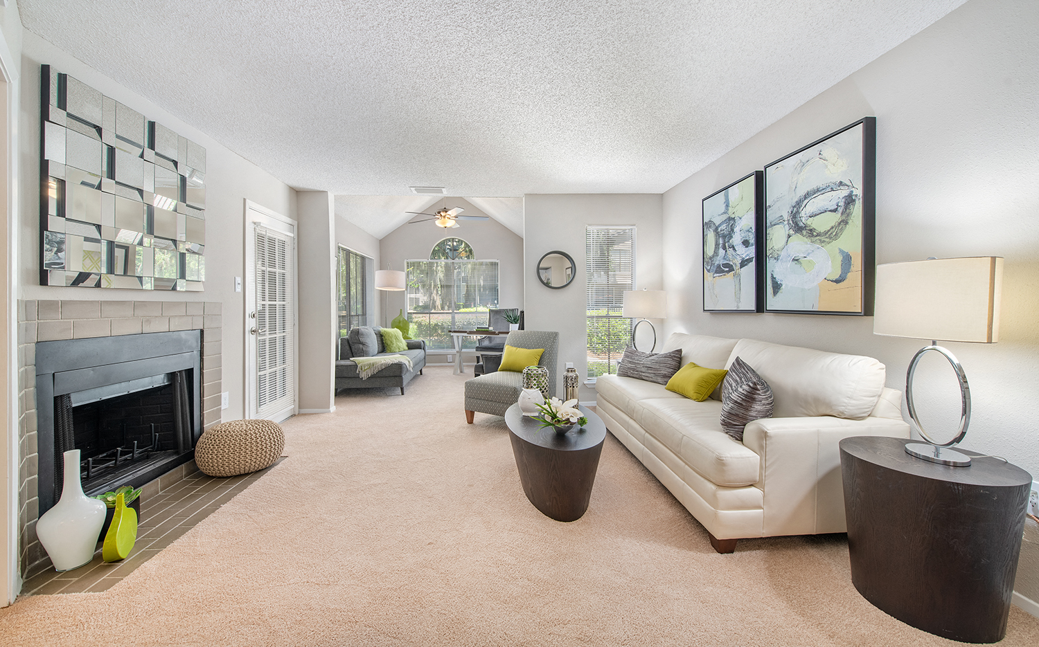 a living room with a white couch and a fireplace
